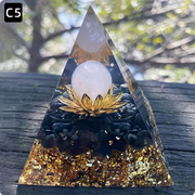 Prisma Calming Energy Pyramid 6CM on a wooden surface, showcasing its crystal composition and elegant design for promoting relaxation.