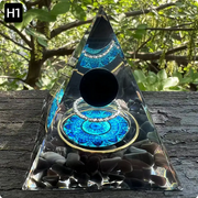 Prisma Calming Energy Pyramid 6CM on wooden surface with serene outdoor backdrop.